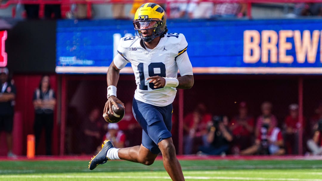 Sep 20, 2025; Lincoln, Nebraska, USA; Michigan Wolverines quarterback Bryce Underwood (19) scrambles against the Nebraska Cornhuskers during the third quarter at Memorial Stadium. Mandatory Credit: Dylan Widger-Imagn Images