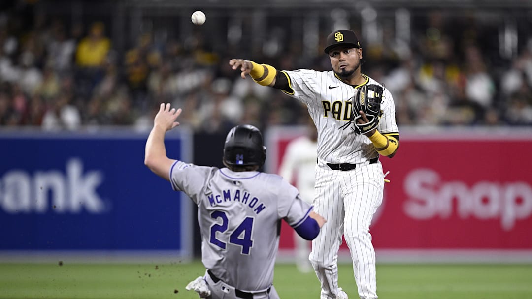 May 13, 2024; San Diego, California, USA; San Diego Padres second baseman Luis Arraez (4) throws to first base after forcing out Colorado Rockies third baseman Ryan McMahon (24) at second base to complete a double play during the sixth inning at Petco Park. Mandatory Credit: Orlando Ramirez-Imagn Images