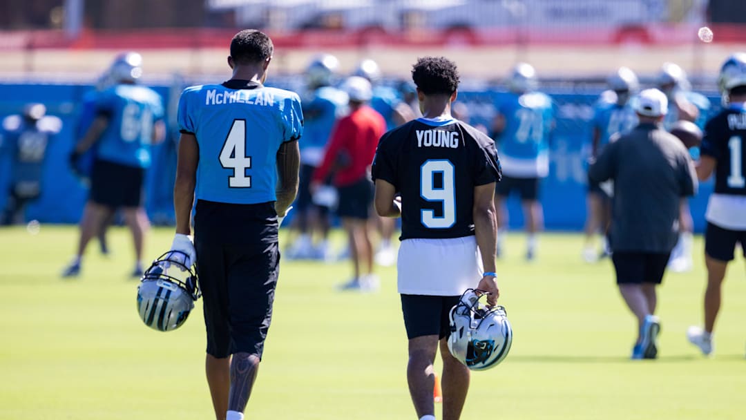 Jul 26, 2025; Charlotte, NC, USA; Carolina Panthers wide receiver Tetairoa McMillan (4) and quarterback Bryce Young (9) talk as they head to stretch during training camp. Jul 26, 2025; Charlotte, NC, USA; Carolina Panthers wide receiver Tetairoa McMillan (4) and quarterback Bryce Young (9) talk as they head to stretch during training camp.
