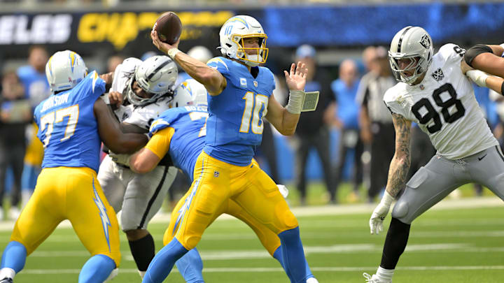 Sep 8, 2024; Inglewood, California, USA; Los Angeles Chargers quarterback Justin Herbert (10) looks to pass in the first half against the Las Vegas Raiders at SoFi Stadium. Mandatory Credit: Jayne Kamin-Oncea-Imagn Images