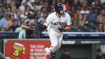 Jul 8, 2025; Houston, Texas, USA; Houston Astros first baseman Victor Caratini (17) drives in a run with a sacrifice fly during the fifth inning against the Cleveland Guardians at Daikin Park. Mandatory Credit: Troy Taormina-Imagn Images