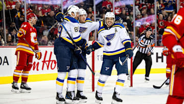 Dec 5, 2024; Calgary, Alberta, CAN; St. Louis Blues left wing Pavel Buchnevich (89) celebrates a goal with left wing Jake Neighbours (63) and center Robert Thomas (18) against the Calgary Flames during the third period at Scotiabank Saddledome. Mandatory Credit: Brett Holmes-Imagn Images
