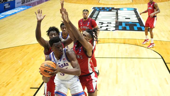 Mar 22, 2026; San Diego, CA, USA; Kansas Jayhawks center Paul Mbiya (34) controls the ball against St. John's Red Storm guard Joson Sanon (3) and St. John's Red Storm forward Zuby Ejiofor (24) in the second half during a second round game of the men's 2026 NCAA Tournament at Viejas Arena. Mandatory Credit: Kirby Lee-Imagn Images