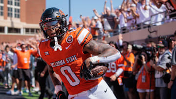 Sep 7, 2024; Stillwater, Oklahoma, USA; Oklahoma State Cowboys running back Ollie Gordon II (0) scores a touchdown in the second overtime against the Arkansas Razorbacks at Boone Pickens Stadium. Mandatory Credit: William Purnell-Imagn Images