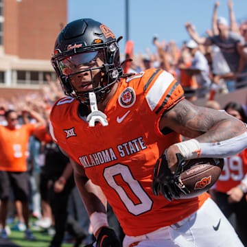 Sep 7, 2024; Stillwater, Oklahoma, USA; Oklahoma State Cowboys running back Ollie Gordon II (0) scores a touchdown in the second overtime against the Arkansas Razorbacks at Boone Pickens Stadium. Mandatory Credit: William Purnell-Imagn Images