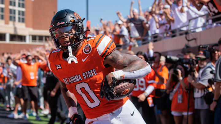 Sep 7, 2024; Stillwater, Oklahoma, USA; Oklahoma State Cowboys running back Ollie Gordon II (0) scores a touchdown in the second overtime against the Arkansas Razorbacks at Boone Pickens Stadium. Mandatory Credit: William Purnell-Imagn Images