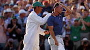 Rory McIlroy celebrates with his caddy, Harry Diamond, after winning in a playoff on the 18th green during the final round of the Masters.