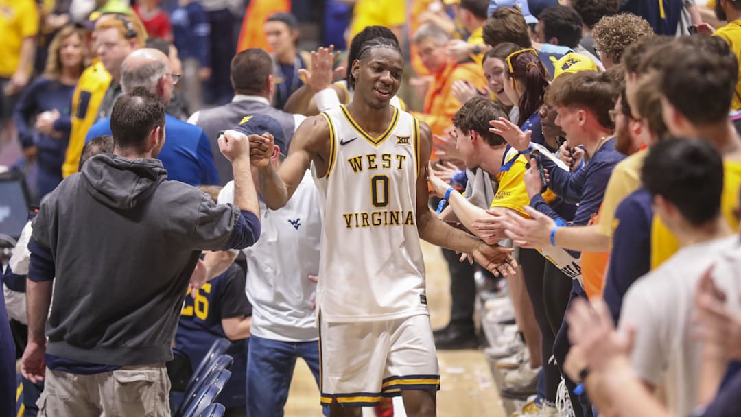 Mar 6, 2026; Morgantown, West Virginia, USA; West Virginia Mountaineers forward Brenen Lorient (0) celebrates with fans after defeating the UCF Knights at Hope Coliseum. Mandatory Credit: Ben Queen-Imagn Images