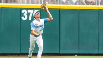 Jun 18, 2024; Omaha, NE, USA; North Carolina Tar Heels left fielder Casey Cook (16) makes a catch for an out against the Florida State Seminoles during the sixth inning at Charles Schwab Field Omaha. Mandatory Credit: Dylan Widger-USA TODAY Sports