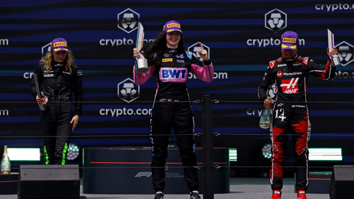 May 4, 2024; Miami Gardens, Florida, USA; F1 Academy driver Doriane Pin (28), F1 Academy driver Abbi Pulling (9) and F1 Academy driver Chloe Chambers (14) celebrate on the podium after the F1 Academy First Race at Miami International Autodrome. Pulling won first place, Pin won second place and Chambers won third place. Mandatory Credit: Peter Casey-USA TODAY Sports