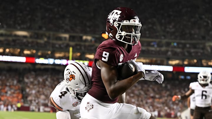 Sep 21, 2024; College Station, Texas, USA; Texas A&M Aggies wide receiver Jahdae Walker (9) scores a touchdown during the third quarter as Bowling Green Falcons cornerback Edward Rhambo (4) defends at Kyle Field. Mandatory Credit: Maria Lysaker-Imagn Images. 