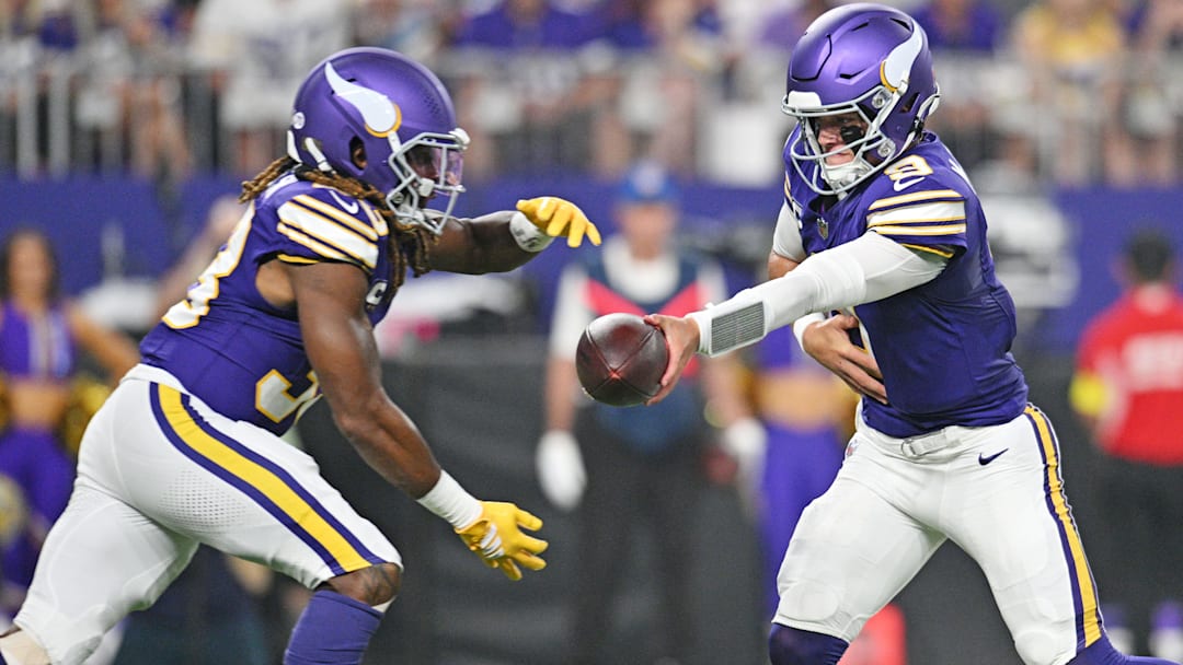 Minnesota Vikings quarterback J.J. McCarthy (9) hands off the ball to Minnesota Vikings running back Aaron Jones Sr. (33) during the first half at U.S. Bank Stadium.