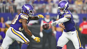 Minnesota Vikings quarterback J.J. McCarthy (9) hands off the ball to Minnesota Vikings running back Aaron Jones Sr. (33) during the first half at U.S. Bank Stadium.