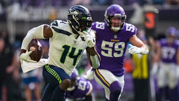 Sep 26, 2021; Minneapolis, Minnesota, USA; Seattle Seahawks wide receiver DK Metcalf (14) runs with the ball during the first quarter against Minnesota Vikings at U.S. Bank Stadium.