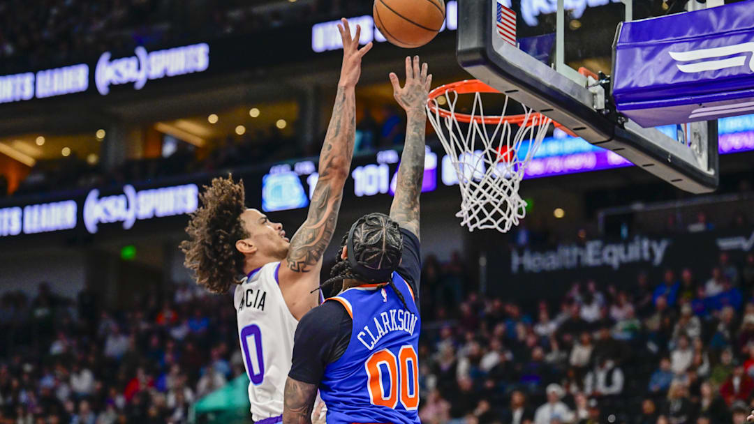 Mar 11, 2026; Salt Lake City, Utah, USA; New York Knicks guard Jordan Clarkson (00) jumps to block a shot from Utah Jazz forward Andersson Garcia (0) during the second half at Delta Center. Mandatory Credit: Peter Creveling-Imagn Images