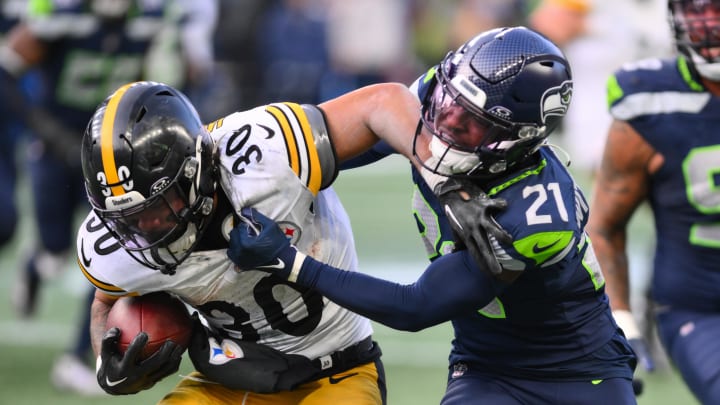 Dec 31, 2023; Seattle, Washington, USA; Seattle Seahawks cornerback Devon Witherspoon (21) tackles Pittsburgh Steelers running back Jaylen Warren (30) during the second half at Lumen Field. Mandatory Credit: Steven Bisig-USA TODAY Sports