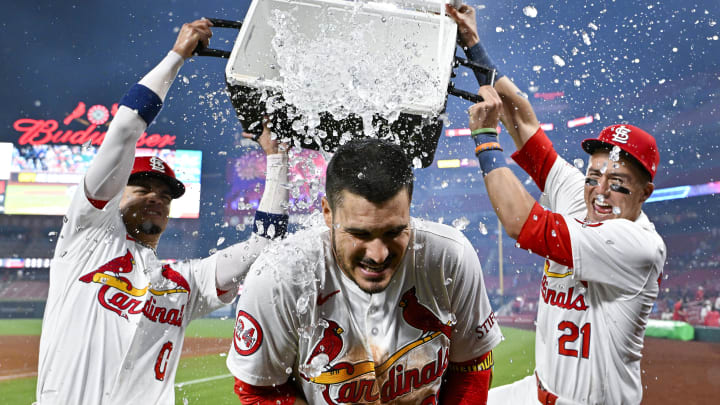 Aug 21, 2024; St. Louis, Missouri, USA;  St. Louis Cardinals third baseman Nolan Arenado (28) is doused with water by shortstop Masyn Winn (0) and center fielder Lars Nootbaar (21) after hitting a walk-off grand slam against the Milwaukee Brewers during the tenth inning at Busch Stadium. Mandatory Credit: Jeff Curry-USA TODAY Sports