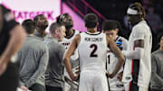 Dec 19, 2024; Athens, Georgia, USA; Georgia Bulldogs head coach Mike White (center left) talks to his players during the game against the Buffalo Bulls at Stegeman Coliseum. Mandatory Credit: Dale Zanine-Imagn Images