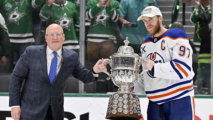 May 29, 2025; Dallas, Texas, USA; NHL deputy commissioner Bill Daly and Edmonton Oilers center Connor McDavid (97) pose with the trophy after winning the Western Conference Final of the 2025 Stanley Cup Playoffs at American Airlines Center. Mandatory Credit: Jerome Miron-Imagn Images