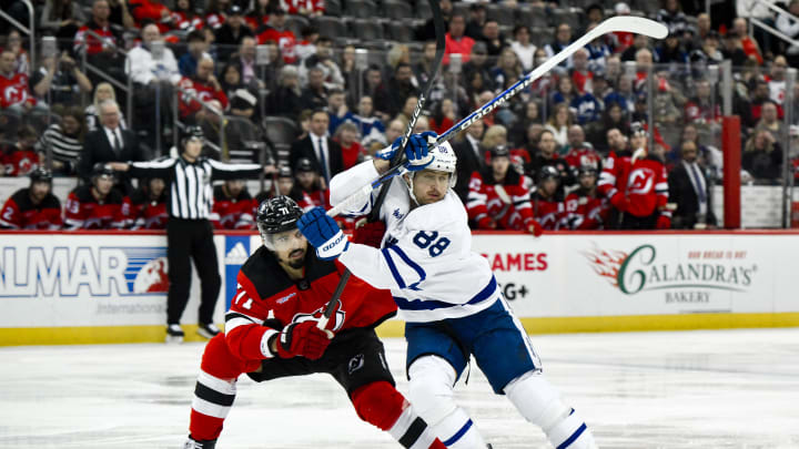 Apr 9, 2024; Newark, New Jersey, USA; Toronto Maple Leafs right wing William Nylander (88) tries to skate past New Jersey Devils defenseman Jonas Siegenthaler (71) during the third period at Prudential Center. Mandatory Credit: John Jones-USA TODAY Sports