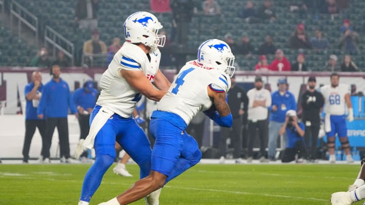 Oct 20, 2023; Philadelphia, Pennsylvania, USA; SMU Mustangs quarterback Preston Stone (2) hands the ball off to SMU Mustangs running back Jaylan Knighton (4) during the first half at Lincoln Financial Field. Mandatory Credit: Gregory Fisher-USA TODAY Sports