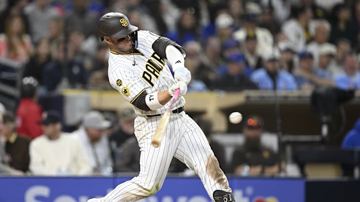 Apr 27, 2026; San Diego, California, USA; San Diego Padres third baseman Ty France (25) hits an RBI triple during the seventh inning against the Chicago Cubs at Petco Park. Mandatory Credit: Denis Poroy-Imagn Images