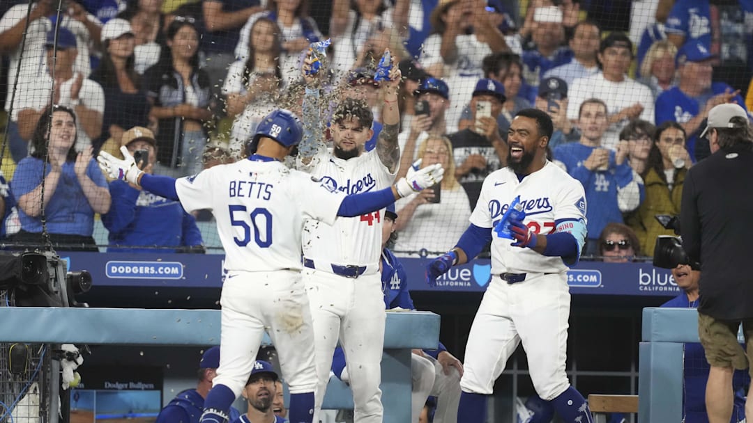 Jul 3, 2025; Los Angeles, California, USA; Los Angeles Dodgers shortstop Mookie Betts (50) is showered with sunflower seeds by center fielder Andy Pages (44) and right fielder Teoscar Hernandez (37) after homering to left center field in the seventh inning at Dodger Stadium. Mandatory Credit: Kirby Lee-Imagn Images Jul 3, 2025; Los Angeles, California, USA; Los Angeles Dodgers shortstop Mookie Betts (50) is showered with sunflower seeds by center fielder Andy Pages (44) and right fielder Teoscar Hernandez (37) after homering to left center field in the seventh inning at Dodger Stadium. Mandatory Credit: Kirby Lee-Imagn Images