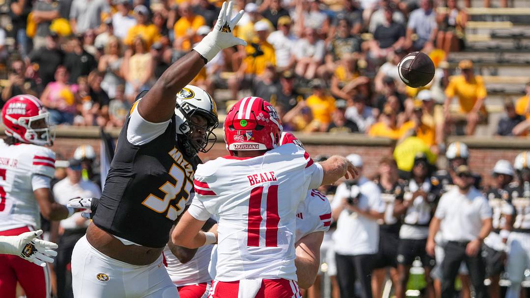 Sep 13, 2025; Columbia, Missouri, USA; Louisiana-Lafayette Ragin Cajuns quarterback Daniel Beale (11) throws a pass as Missouri Tigers defensive tackle Marquis Gracial (33) tries to block during the first half of the game at Faurot Field at Memorial Stadium. Mandatory Credit: Denny Medley-Imagn Images
