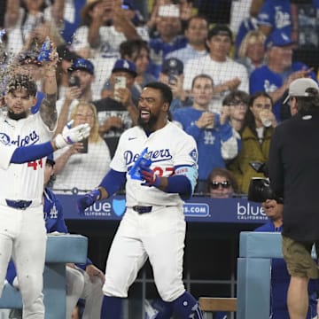 Jul 3, 2025; Los Angeles, California, USA;  Los Angeles Dodgers shortstop Mookie Betts (50) is showered with sunflower seeds by center fielder Andy Pages (44) and right fielder Teoscar Hernandez (37) after homering to left center field in the seventh inning at Dodger Stadium. Mandatory Credit: Kirby Lee-Imagn Images