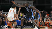 Feb 25, 2025; Coral Gables, Florida, USA;  Duke Blue Devils center Khaman Maluach (9) defends Miami (Fl) Hurricanes guard Jalil Bethea (3) during the first half at Watsco Center.