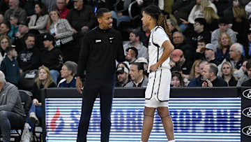 Mar 1, 2025; Providence, Rhode Island, USA; Providence Friars head coach Kim English speaks to guard Justyn Fernandez (4)