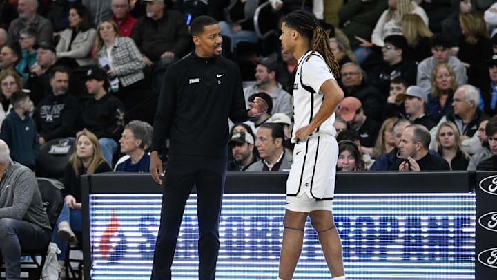 Mar 1, 2025; Providence, Rhode Island, USA; Providence Friars head coach Kim English speaks to guard Justyn Fernandez (4)