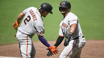 Aug 21, 2025; San Diego, California, USA; San Francisco Giants designated hitter Rafael Devers (16) is congratulated by San Francisco Giants shortstop Willy Adames (2) after hitting a solo home run during the sixth inning against the San Diego Padres at Petco Park. Mandatory Credit: Denis Poroy-Imagn Images