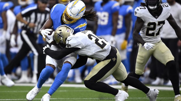 Los Angeles Chargers wide receiver Quentin Johnston (1) is tackled by New Orleans Saints safety Johnathan Abram (24)