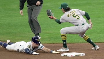 Milwaukee Brewers' Caleb Durbin (21) beats the throw to Oakland Athletics shortstop Jacob Wilson (5) to steal second base during the fourth inning of their game Sunday, April 20, 2025 at American Family Field in Milwaukee, Wisconsin.