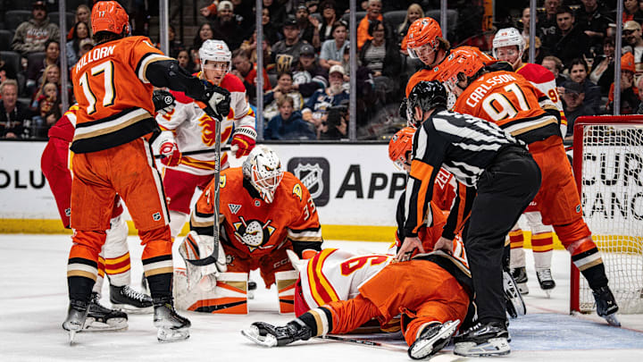 Apr 4, 2026; Anaheim, California, USA; Anaheim Ducks and Calgary Flames pile on around goal during the first period at Honda Center. Mandatory Credit: Corinne Votaw-Imagn Images