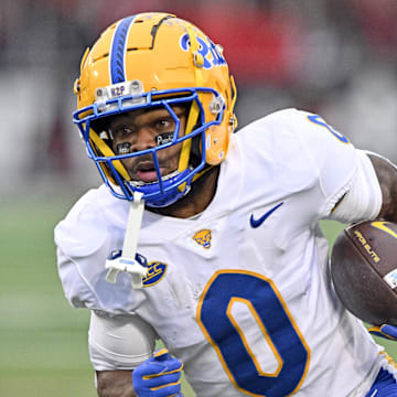 Nov 23, 2024; Louisville, Kentucky, USA;  Pittsburgh Panthers running back Desmond Reid (0) runs against the Louisville Cardinals during the first quarter at L&N Federal Credit Union Stadium. Mandatory Credit: Jamie Rhodes-Imagn Images