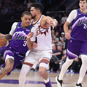 Oct 27, 2025; Salt Lake City, Utah, USA; Utah Jazz guard Keyonte George (3) drives against Phoenix Suns guard Devin Booker (1) during overtime at Delta Center. Mandatory Credit: Rob Gray-Imagn Images