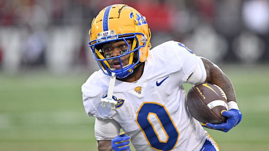 Pittsburgh Panthers running back Desmond Reid (0) runs against the Louisville Cardinals during the first quarter at L&N Federal Credit Union Stadium.
