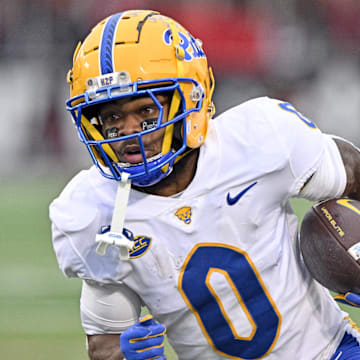 Nov 23, 2024; Louisville, Kentucky, USA;  Pittsburgh Panthers running back Desmond Reid (0) runs against the Louisville Cardinals during the first quarter at L&N Federal Credit Union Stadium. Mandatory Credit: Jamie Rhodes-Imagn Images