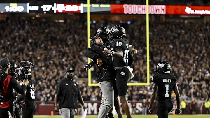 Oct 26, 2024; College Station, Texas, USA; Texas A&M Aggies quarterback Marcel Reed (10) celebrates after scoring a touchdown with Offensive Coordinator/Quarterbacks coach Collin Klein in the third quarter against the LSU Tigers at Kyle Field. Mandatory Credit: Maria Lysaker-Imagn Images. Oct 26, 2024; College Station, Texas, USA; Texas A&M Aggies quarterback Marcel Reed (10) celebrates after scoring a touchdown with Offensive Coordinator/Quarterbacks coach Collin Klein in the third quarter against the LSU Tigers at Kyle Field. Mandatory Credit: Maria Lysaker-Imagn Images.
