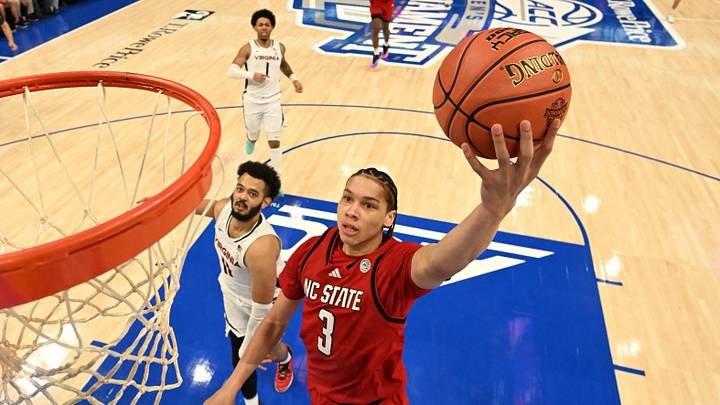 Mar 12, 2026; Charlotte, NC, USA; NC State Wolfpack guard Matt Able (3) scores as Virginia Cavaliers forward Devin Tillis (11) defends in the first half at Spectrum Center. Mandatory Credit: Bob Donnan-Imagn Images
