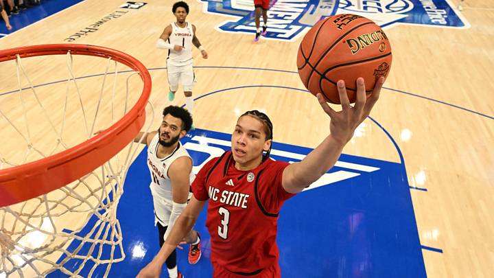 Mar 12, 2026; Charlotte, NC, USA; NC State Wolfpack guard Matt Able (3) scores as Virginia Cavaliers forward Devin Tillis (11) defends in the first half at Spectrum Center. Mandatory Credit: Bob Donnan-Imagn Images