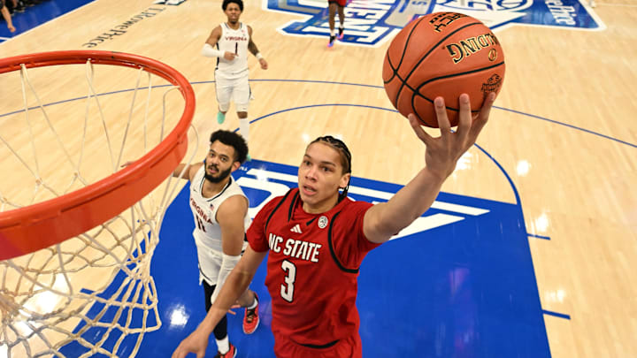 Mar 12, 2026; Charlotte, NC, USA; NC State Wolfpack guard Matt Able (3) scores as Virginia Cavaliers forward Devin Tillis (11) defends in the first half at Spectrum Center. Mandatory Credit: Bob Donnan-Imagn Images