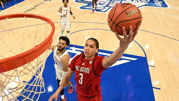 Mar 12, 2026; Charlotte, NC, USA; NC State Wolfpack guard Matt Able (3) scores as Virginia Cavaliers forward Devin Tillis (11) defends in the first half at Spectrum Center. Mandatory Credit: Bob Donnan-Imagn Images
