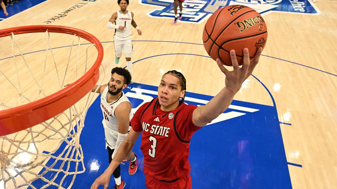Mar 12, 2026; Charlotte, NC, USA; NC State Wolfpack guard Matt Able (3) scores as Virginia Cavaliers forward Devin Tillis (11) defends in the first half at Spectrum Center. Mandatory Credit: Bob Donnan-Imagn Images