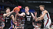 Jan 2, 2025; Spokane, Washington, USA; Portland Pilots forward Austin Rapp (22) rebounds against Gonzaga Bulldogs forward Ben Gregg (33) in the first half at Spokane Veterans Memorial Arena. Mandatory Credit: James Snook-Imagn Images