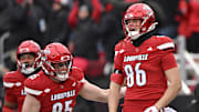 Nov 29, 2025; Louisville, Kentucky, USA;  Louisville Cardinals tight end Jacob Stewart (86) celebrates with tight end Nate Kurisky (85) after scoring a touchdown against the Kentucky Wildcats during the first half at L&N Federal Credit Union Stadium. Mandatory Credit: Jamie Rhodes-Imagn Images