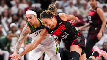 Seattle Storm forward Gabby Williams (5) and Indiana Fever guard Aerial Powers (23) go for the ball Tuesday, Aug. 26, 2025, during a game between the Indiana Fever and the Seattle Storm at Gainbridge Fieldhouse in Indianapolis. The Indiana Fever defeated the Seattle Storm, 95-75.
