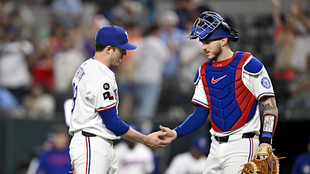 Texas Rangers relief pitcher Phil Maton and catcher Jonah Heim celebrate the win against the Minnesota Twins at Globe Life.